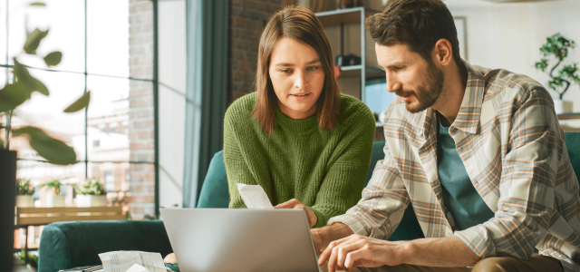 couple working on a laptop in the living room