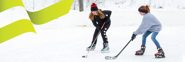 Two girls playing ice hockey