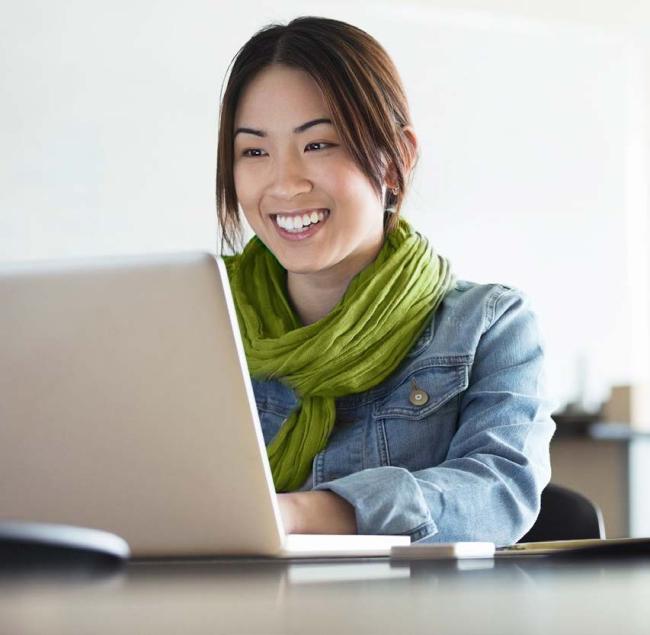 Woman smiling at her computer