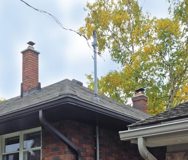 Trees encroaching on power lines above a house