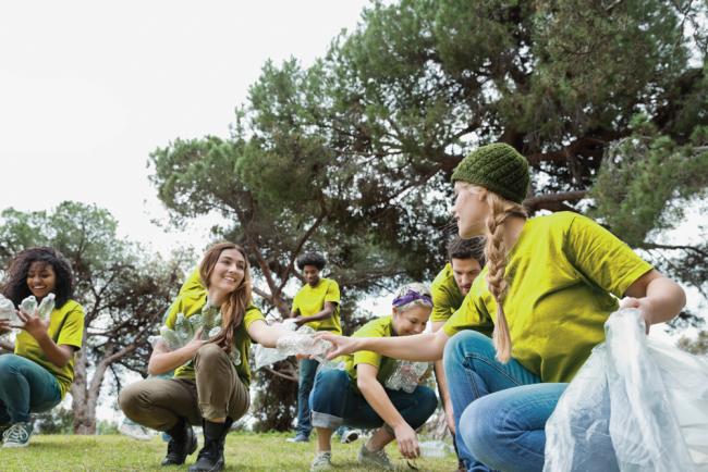 volunteers cleaning plastic bottles out of a park