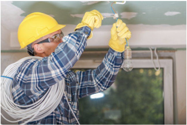 Electrician installing a light