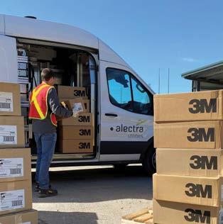 Worker unloading boxes out of an alectra vehicle