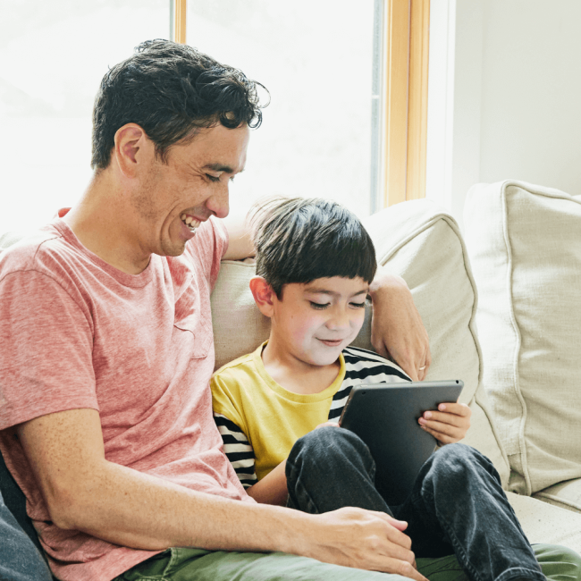 Dad and son reading on the couch